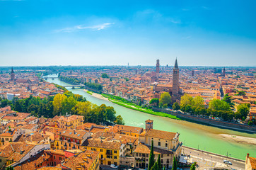 Obraz premium Aerial view of Verona historical city centre, bridges across Adige river, Basilica di Santa Anastasia, medieval buildings with red tiled roofs, Veneto Region, Italy. Verona cityscape, panoramic view.