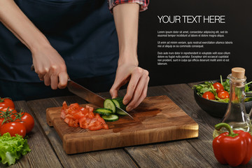 Woman cooking fresh healthy salad. Female hands cutting vegetables on board on wooden table with sample text.