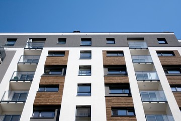 Urban lifestyle. Facade of new modern residential house. Apartment building in the city. 