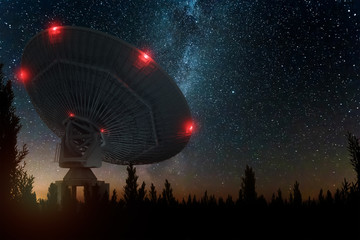Radio telescope, a large satellite dish against the night sky tracks the stars. Technology concept,...
