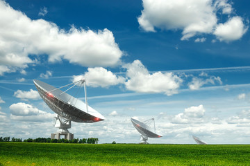 White Radio Telescope, a large satellite dish on a background of blue sky, radar. Technology...