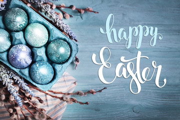 Happy Easter. Congratulatory easter background. Easter eggs and flowers. Selective focus. Top view.