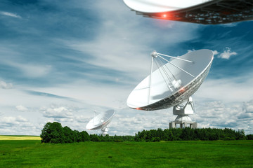 White Radio Telescope, a large satellite dish on a background of blue sky, radar. Technology...