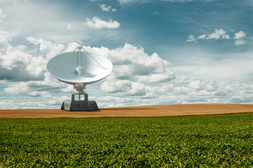 White Radio Telescope, a large satellite dish on a background of blue sky, radar. Technology concept, search for extraterrestrial life, wiretap of space. Mixed medium, copy space.