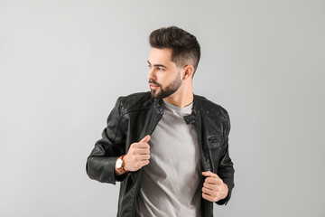 Handsome man with healthy hair on light background