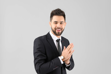 Handsome businessman with healthy hair on light background