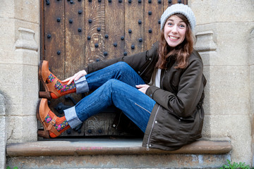A beautiful woman wearing a pair of lovely wooden clog shoes and brown nubuck leather with bright...