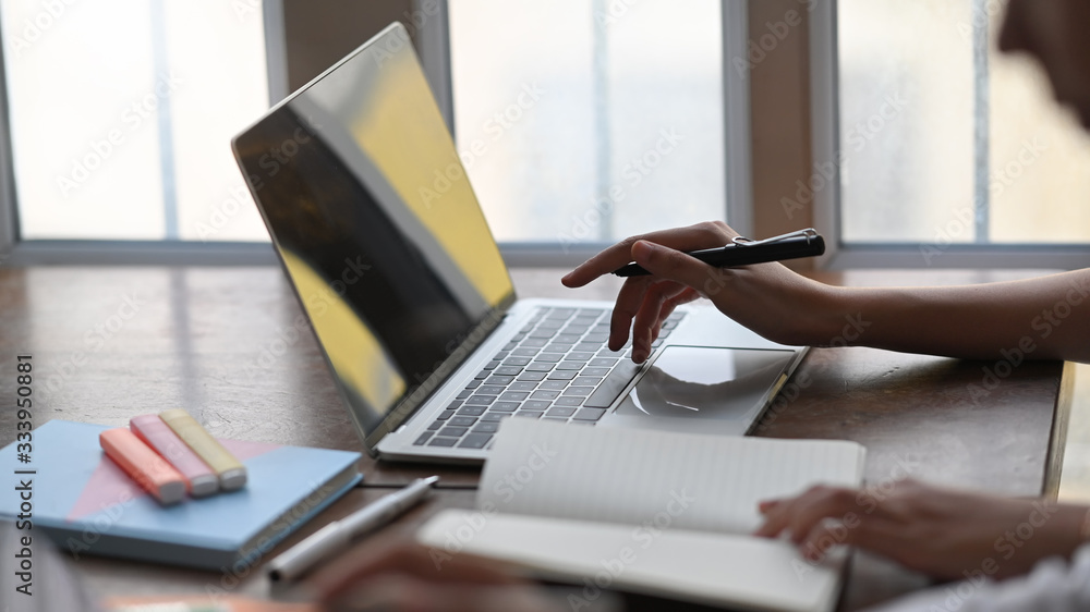 Poster cropped image of graphic designer team working together by using a computer laptop and tablet with k
