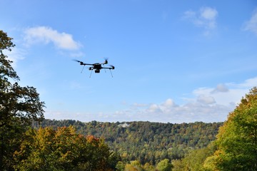 black flying drone in sky