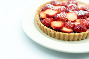 Strawberry tart shot in studio on white background