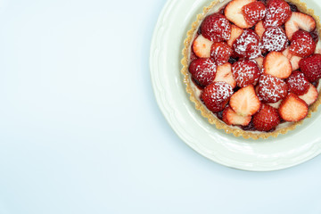 Strawberry tart shot in studio on white background