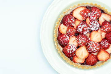 Strawberry tart shot in studio on white background