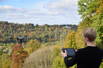 black flying drone in sky
