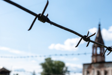 barbed wire closeup on a background of an old building