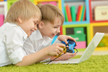 Portrait of two boys playing computer games