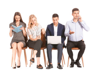 Obraz premium Young business people waiting in line on white background
