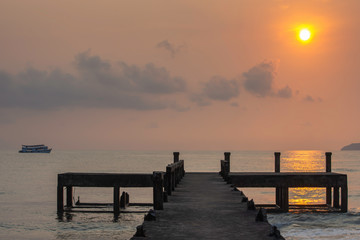 Fototapeta premium Concrete bridge piers and eflection of the sun in the sea.