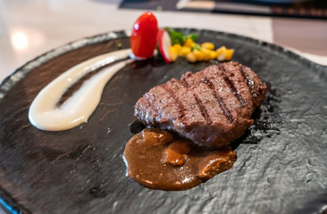 Delicious medium rare wagyu beef  steak with gravy sauce.