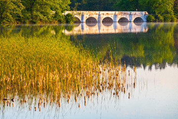 Fototapeta na wymiar Old stone bridge over Vitek pond near Trebon, Southern Bohemia, Czech Republic