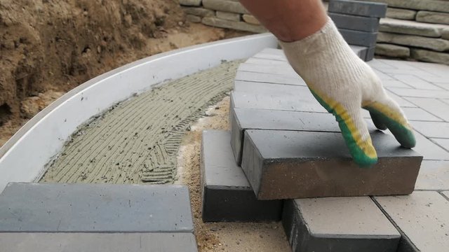 Laying Paving Slabs Close-Up. Road Paving, Construction.