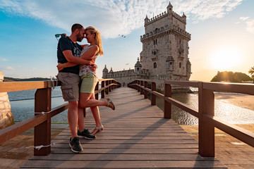 Couple in love on a small bridge leading to tower of Belem in Lisbon