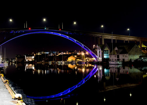 Colour illuminated Risoy Bru bridge in Haugesund city centre the evening, Norway, May 2018