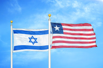 Israel and Liberia two flags on flagpoles and blue cloudy sky
