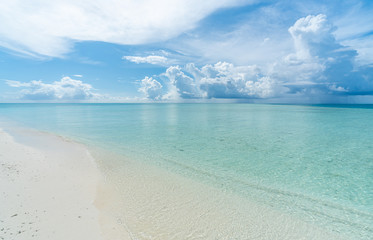 Paradise white sand beach and blue sky in sandbank island, Maldives.