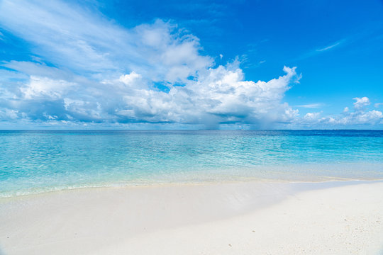 Paradise white sand beach and blue sky in sandbank island, Maldives.
