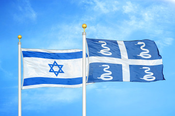Israel and Martinique snake two flags on flagpoles and blue cloudy sky