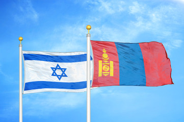 Israel and Mongolia two flags on flagpoles and blue cloudy sky