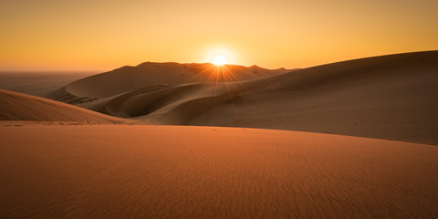 sunset in the desert dunes in Namibia without people