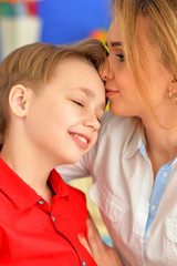 Close up portrait of mother and son posing at home
