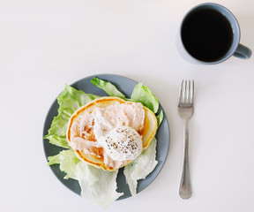 Healthy nutritious tasty breakfast. Pancakes, poached egg on ceramic plate and coffee cup. table setting. food photo. good morning