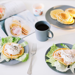 Healthy nutritious tasty breakfast. Pancakes, poached egg on ceramic plate and coffee cup. table setting. food photo. good morning
