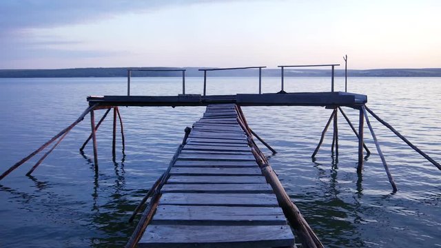 Wooden pier on the lake shore. Twilight. Peace and tranquility.
