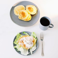 Healthy nutritious tasty breakfast. Pancakes, poached egg on ceramic plate and coffee cup. table setting. food photo. good morning