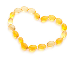 Heart made of pills on white background