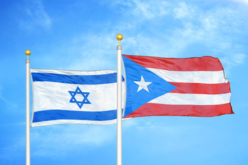 Israel and Puerto Rico two flags on flagpoles and blue cloudy sky