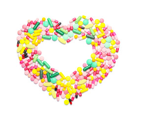 Heart made of pills on white background