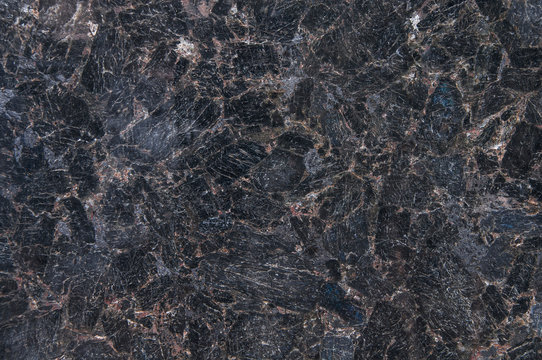 Natural stone granite labradorite. Black granite texture, granite surface and background. Material for decoration, texture, design.