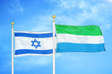 Israel and Sierra Leone two flags on flagpoles and blue cloudy sky