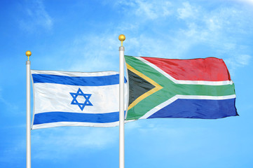 Israel and South Africa two flags on flagpoles and blue cloudy sky