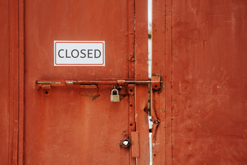 Closed sign hanging outside a restaurant, store, office or other