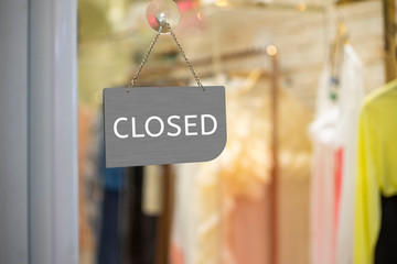 Closed sign hanging outside a restaurant, store, office or other
