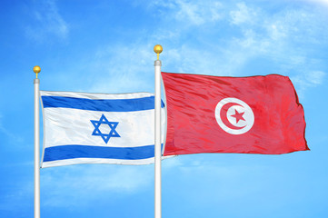 Israel and Tunisia two flags on flagpoles and blue cloudy sky