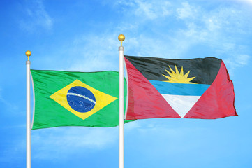 Brazil and Antigua and Barbuda two flags on flagpoles and blue cloudy sky