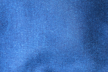 Selective focus blue jean denim top view close up shot to the detail of fabric. textile material and cotton patter tough and durable garment style. For background or wallpaper with copy space for text