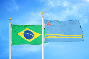 Brazil and Aruba two flags on flagpoles and blue cloudy sky