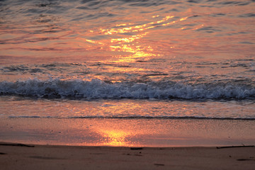 Fototapeta na wymiar Wave rolling over the sands on Candolim Beach, North Goa, India